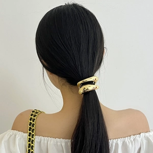 Modern gold double-layer metal hair ring for ponytail shown on long black hair