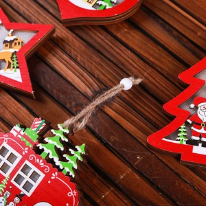 Detail of red and white wooden Christmas ornaments with Santa and reindeer motifs