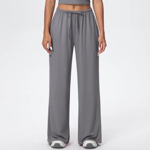 Detailed view of high-waist grey wide-leg trousers with drawstring elastic waistband