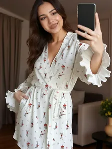 Detail of white robe featuring ruffled wide cuffs and cute cartoon rabbit print patterns