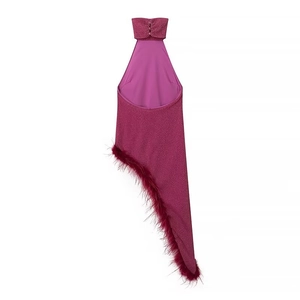 Close-up of pink sequin halter top with delicate feather trim and asymmetrical hem