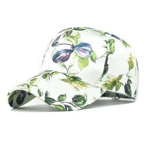 Detail view of floral print baseball cap with plum patterns on satin fabric