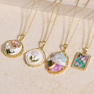 Detailed close-up of four vintage floral pendants with pearls and golden chains