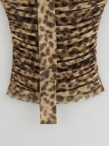 Detail of leopard print mesh fabric with ruched texture and central vertical drawstring