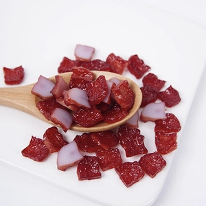 Miniature PVC smoked meat model cubes displayed on a wooden spoon and white tray