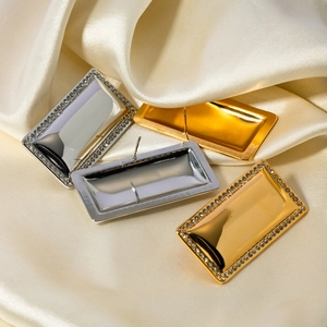Rectangle 18k gold plated stainless steel earrings with crystal inlay on silk background