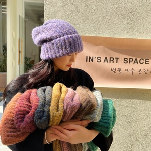 Detail of chunky knit rolled-edge beanies in assorted vibrant winter colors