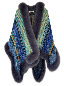 Detail of colorful knitted shawl with wave patterns and grey faux fur trim collar