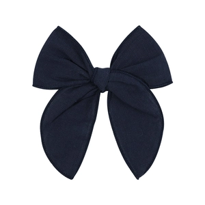 Detail of 4.5 inch navy blue textured cotton bow hair clip for girls on white background