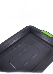 Detail of grey rectangular brownie cake mold with green non-stick handles for easy demoulding
