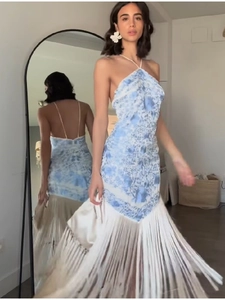 Detail view of backless halter dress showing fringe tassels and blue print in mirror