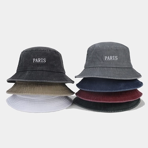 Detailed view of PARIS embroidered bucket hats in seven vintage washed colors
