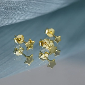 Macro shot of S925 sterling silver hallmark on the back of gold star stud earring