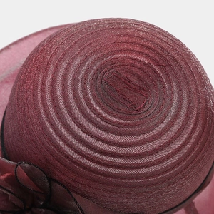 Macro shot of maroon organza sun hat showing spiral sewing and glitter mesh texture