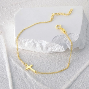 Detailed view of the gold S925 sterling silver cross pendant and hallmark on the delicate chain