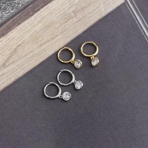 Detail view of gold and silver S925 sterling silver hoop earrings with round zircon stones