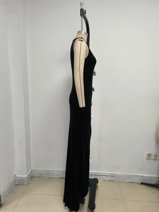 Side view of slim-fit black velvet maxi dress with elegant white bow details