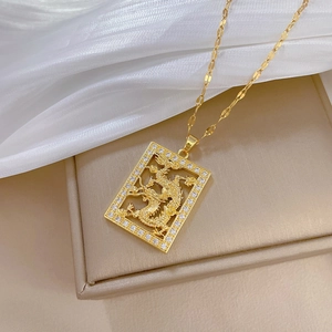 Detailed view of a gold dragon rectangular pendant with sparkling pave crystals