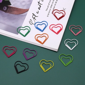 Colorful heart-shaped paper clips with double-layered design on a green background