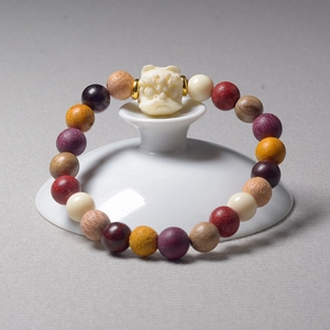 Multi-colored buddhist prayer bead bracelet with a white carved lion and golden spacers