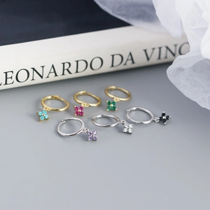 Close-up of geometric S925 sterling silver hoop earrings with multicolored flower charms