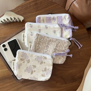 Floral cotton mini storage bags set with zippers and tassels in a lifestyle setup