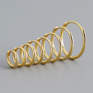Set of seven S925 sterling silver hoop earrings in various sizes with polished gold finish