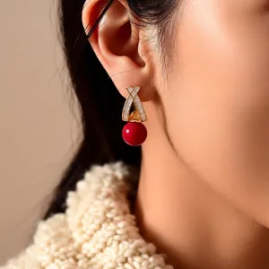 Elegant 18k gold plated earrings with zircon cross design and red sphere pendant