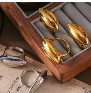 Close-up of gold and silver chunky geometric rings in a velvet jewelry box display