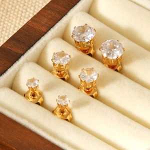 Three pairs of gold-plated stainless steel stud earrings with round cubic zirconia in luxury box