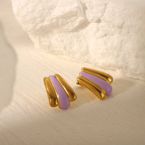 Macro detail of 18k gold plated stainless steel earrings with purple enamel inlay