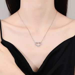 Elegant s925 silver heart shaped moissanite necklace worn by a model on collarbone