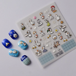 5D embossed cartoon duck nail stickers with 3D relief texture on blue glitter nails