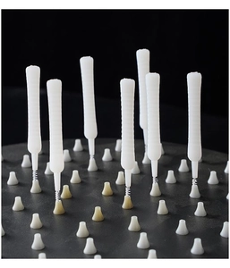 Macro detail of white micro shower nozzle cleaning brushes on textured base