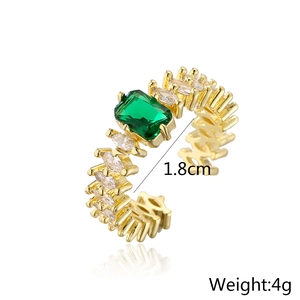 Detail view of gold geometric open ring with green zircon and 1.8cm inner diameter measurement