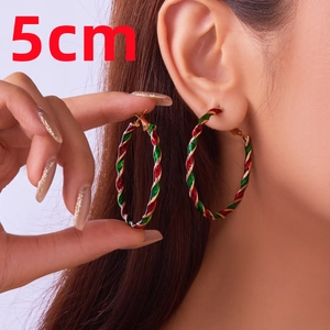 Detailed view of 5cm Christmas hoop earrings with red and green spiral texture