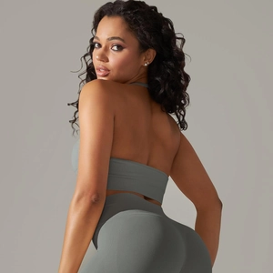 Detail of dark grey seamless ribbed gym set showing open back top and high waist leggings