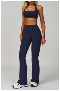 Detail of navy blue high-stretch yoga set featuring halter sports bra and flared pants