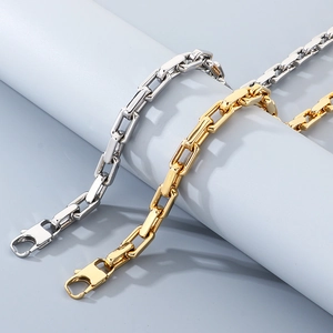 Detail of 18K gold and silver 9mm square O-link chain necklaces on display stands
