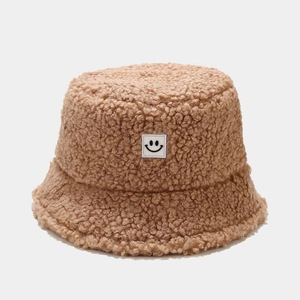 Brown teddy fleece bucket hat for women with a minimalist white square smiley face patch