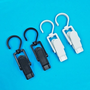 Detail of 360-degree rotating plastic laundry clips with hooks in black and white colors