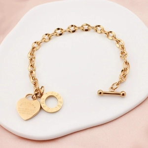 Gold stainless steel OT buckle bracelet featuring heart and round scripture pendants