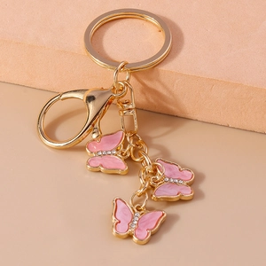Detail of pink butterfly keychain with gold finish, sparkling rhinestones and lobster clasp