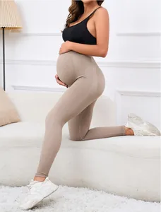 Macro detail of high-waisted seamless maternity leggings showing stretch and belly support