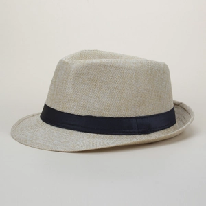 Detail view of a beige woven jazz fedora hat featuring a classic black decorative ribbon band