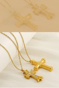 Macro view of gold cross necklaces with polished finish and sparkling rhinestones