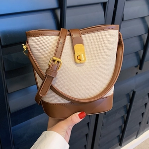 Retro contrast color bucket bag in beige and brown canvas with gold buckle and top handle