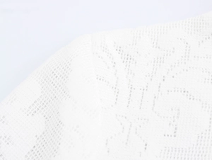 Close-up of elegant white lace texture on the shoulder of a slim-fit evening dress