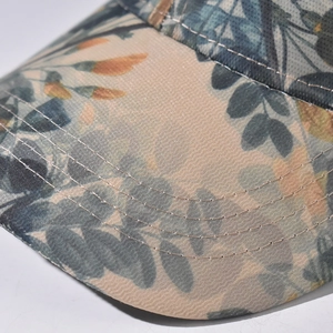Detailed close-up of baseball cap brim featuring floral patterns and precise stitching