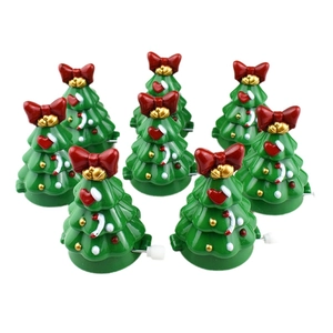 Set of 8 green wind-up Christmas tree toys with red bows and gold bells on white background